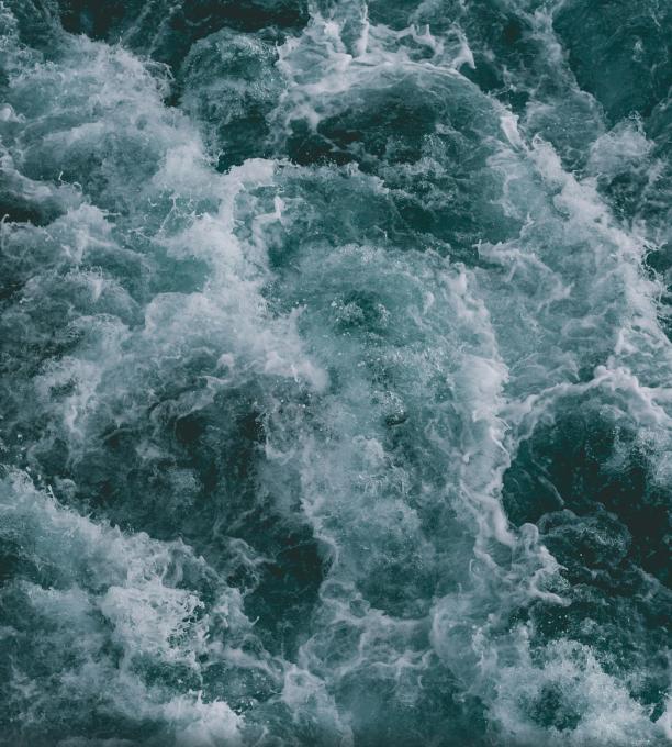 A stormy ocean with waves as seen from above.